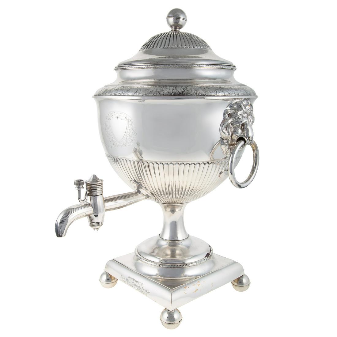 George III-Style Silver Plated Hot Water Urn: 20th century; square base, supporting a generous sized urn, gadrooned border below the waist, finely chased monogram shield, and border along the neck, with hot water nozzle and lion's masque ring-pul