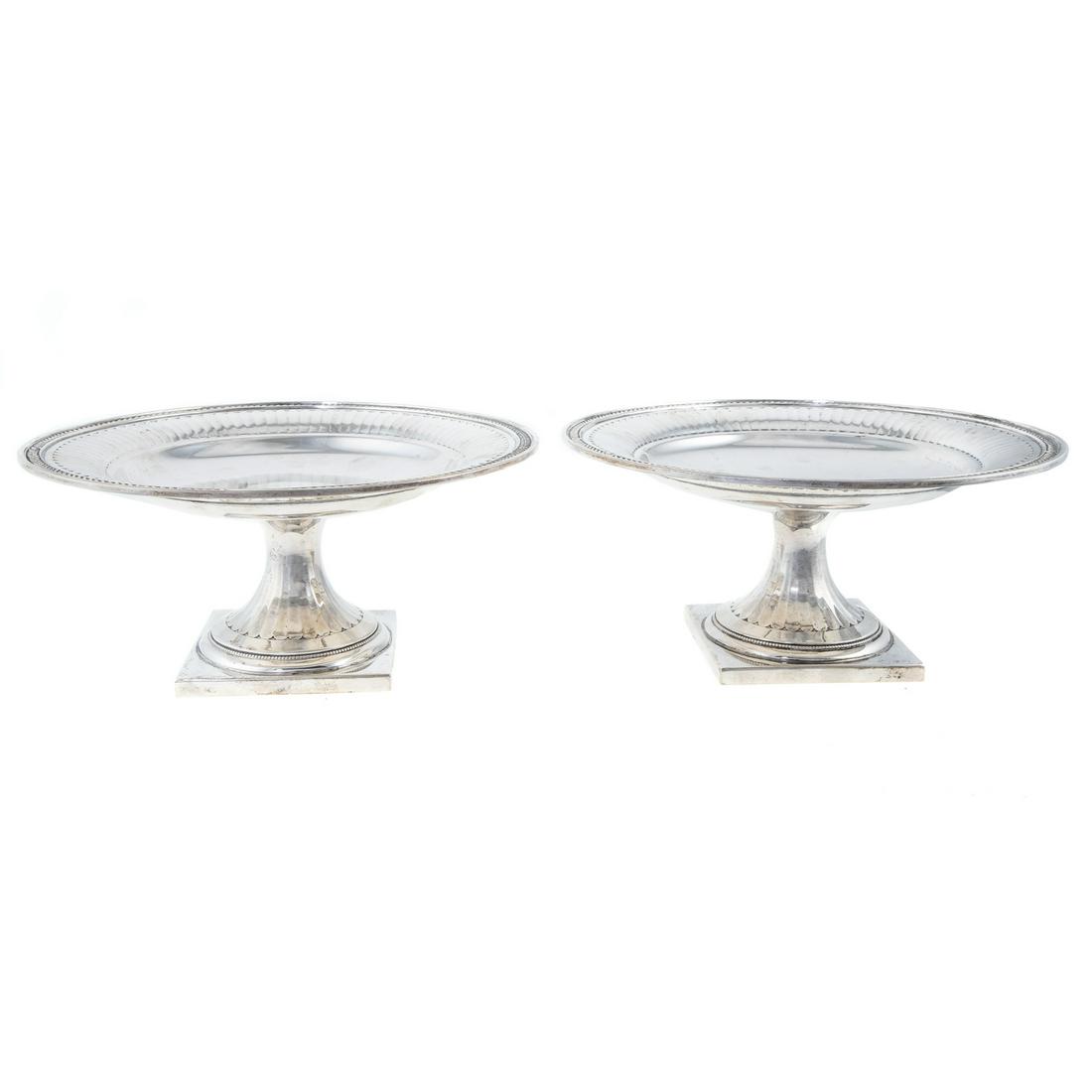 Pair George III-Style Sterling Pedestal Dishes: Retailed by Brand Chatillon Co., New York, c.1910-1940s; square foot, squat columnar standard, supporting a circular dish with fluted border, leafy rim; 4 1/4 in. H, 9 in. Diam., 40.75 ozt.