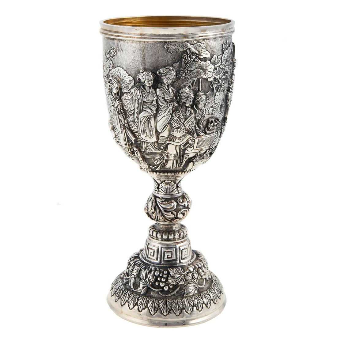 Chinese Export Sterling Goblet: Mark of Luen Hing, Shanghai; generous sized bowl with gilt interior, with high-relief sculptural decoration, depicting a procession of ladies against an interior scene with lotus plants, with an empty