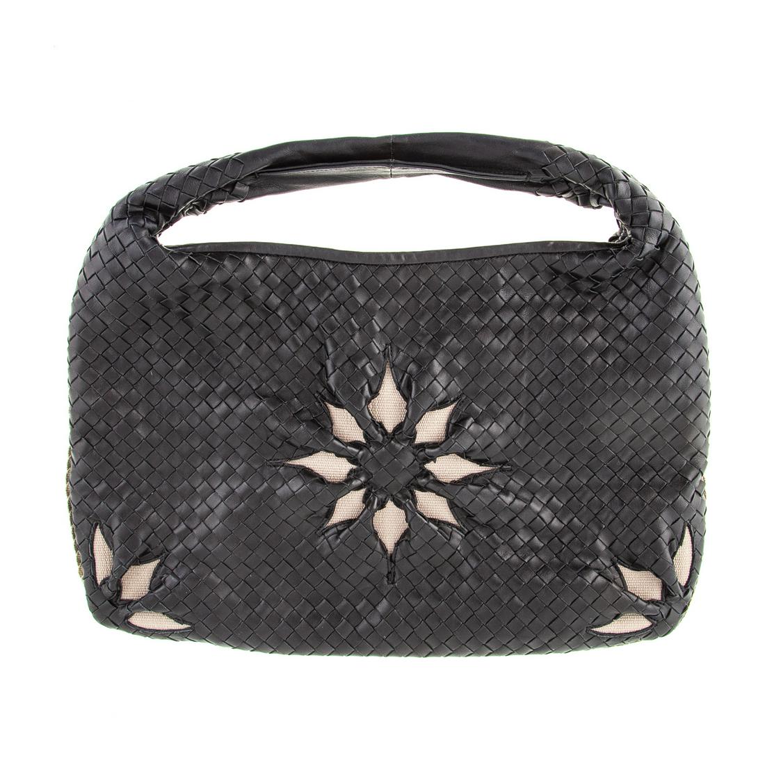 A Bottega Veneta Intrecciato Leather Flower Hobo: A black Intrecciato leather Bottega Veneta Flower hobo with gold tone hardware, single top handle with twisted canvas trim and floral cut outs at front. Suede lining with zipper wall pocket, cell phon