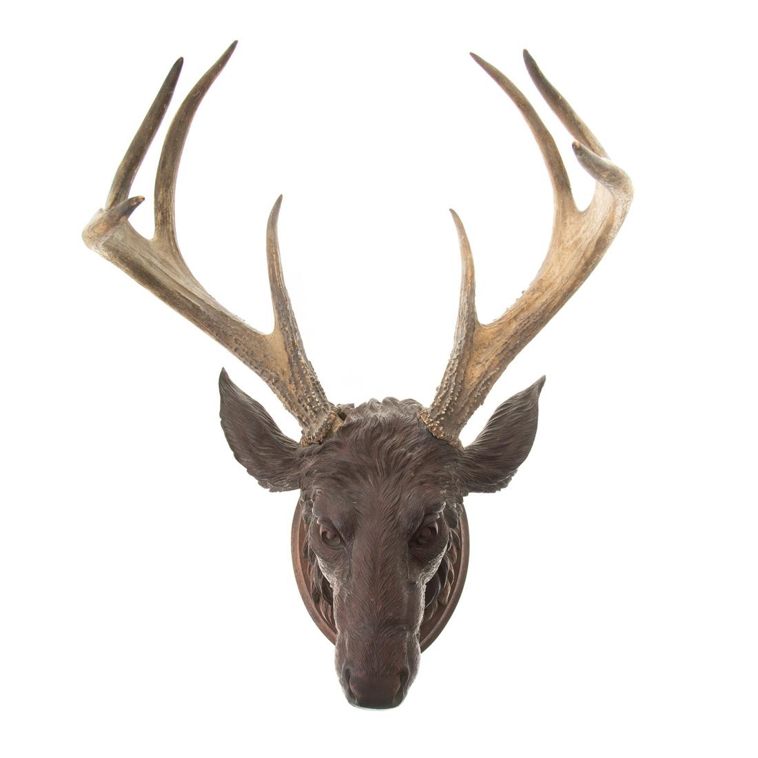 Black Forest Carved Walnut Elk Head Trophy: Early 20th century; well carved elk head with pair of real antlers, mounted on back board for wall hanging, 21 in. H., 16 in. W.