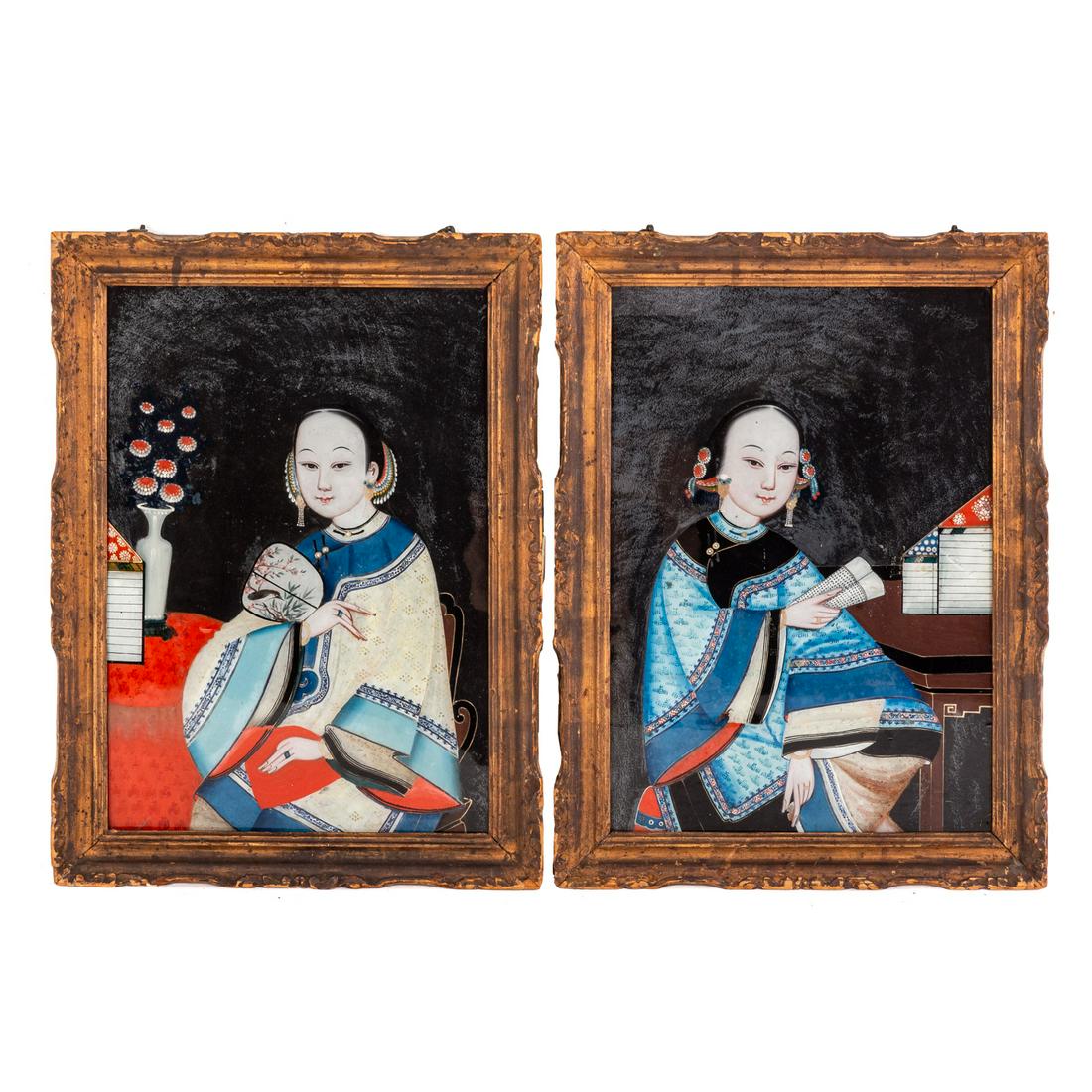 A Pair of Chinese Reverse Painted Glass Maidens: Second half-19th century; each picture depicting young woman in exotic interior, 13 x 20 in. in period carved wood frames.