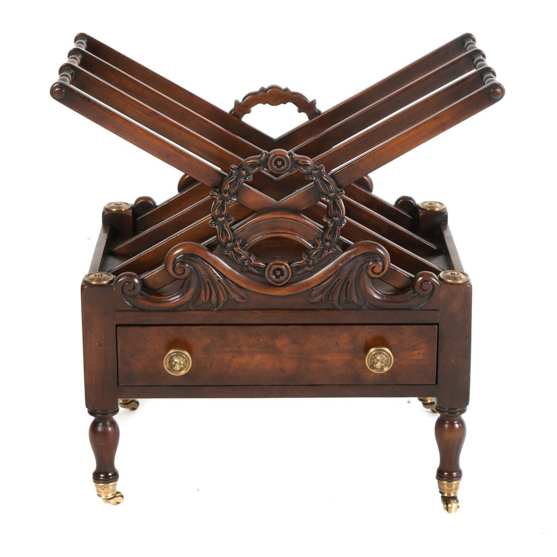 Theodore Alexander Althorp Magazine Rack: 20th century; mahogany with elaborate laurel wreath carvings, having brass mounts, and single drawer stamped with Althorp logo. 24 in. H., 23 in. W., 14 in. D.