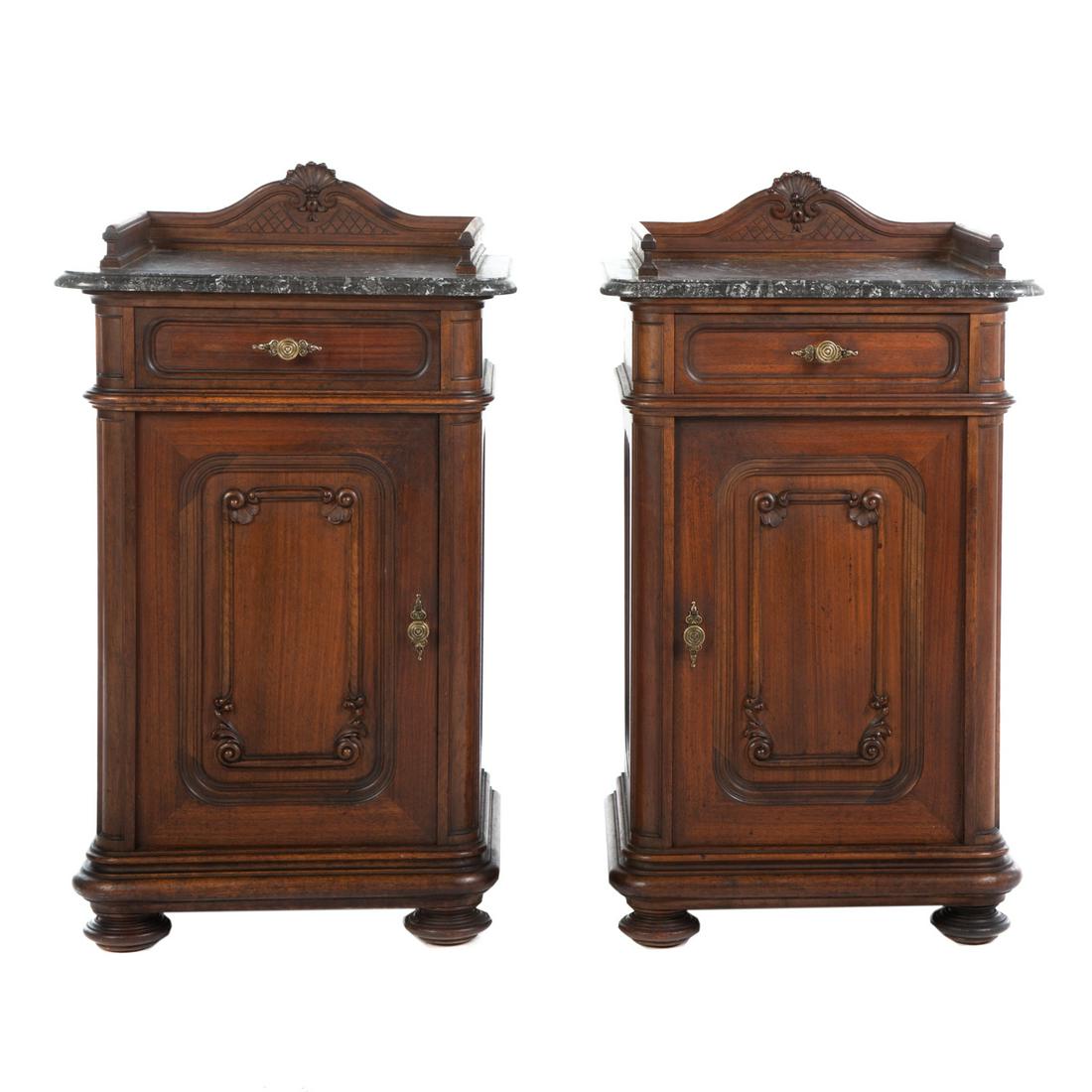 A Pair of Renaissance Revival Marble Top Stands: Circa 1870; black marble top with walnut gallery, single drawer, over cabinet door. 36 in. H., 21 in. W., 19 in. D.