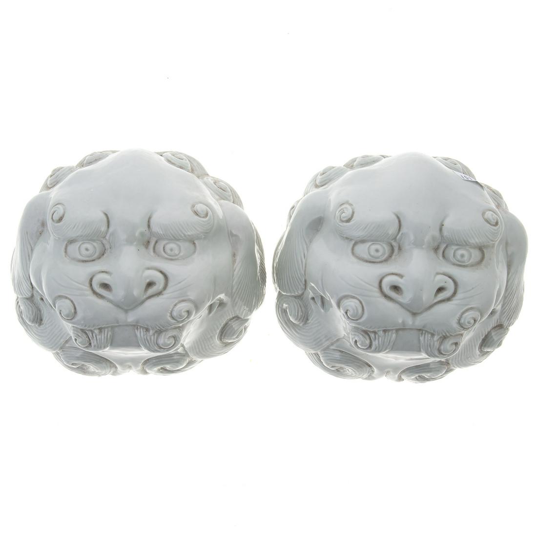 A Pair of Chinese Porcelain Foo Dog Mask Wall Pockets: Blanc de Chine food dog mask wall pockets, 4 in. H., 6 in. W.