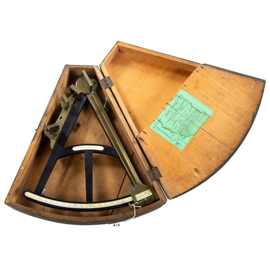 Wilkinson & Sons Brass and Ebony Octant: London, circa 1830: type commonly known as "Hadley's Quadrant;" with ebony frame, 15 in. L.; housed in a painted wood step-top box, with interior label of Henry Glover, maker and repairer of nautical 