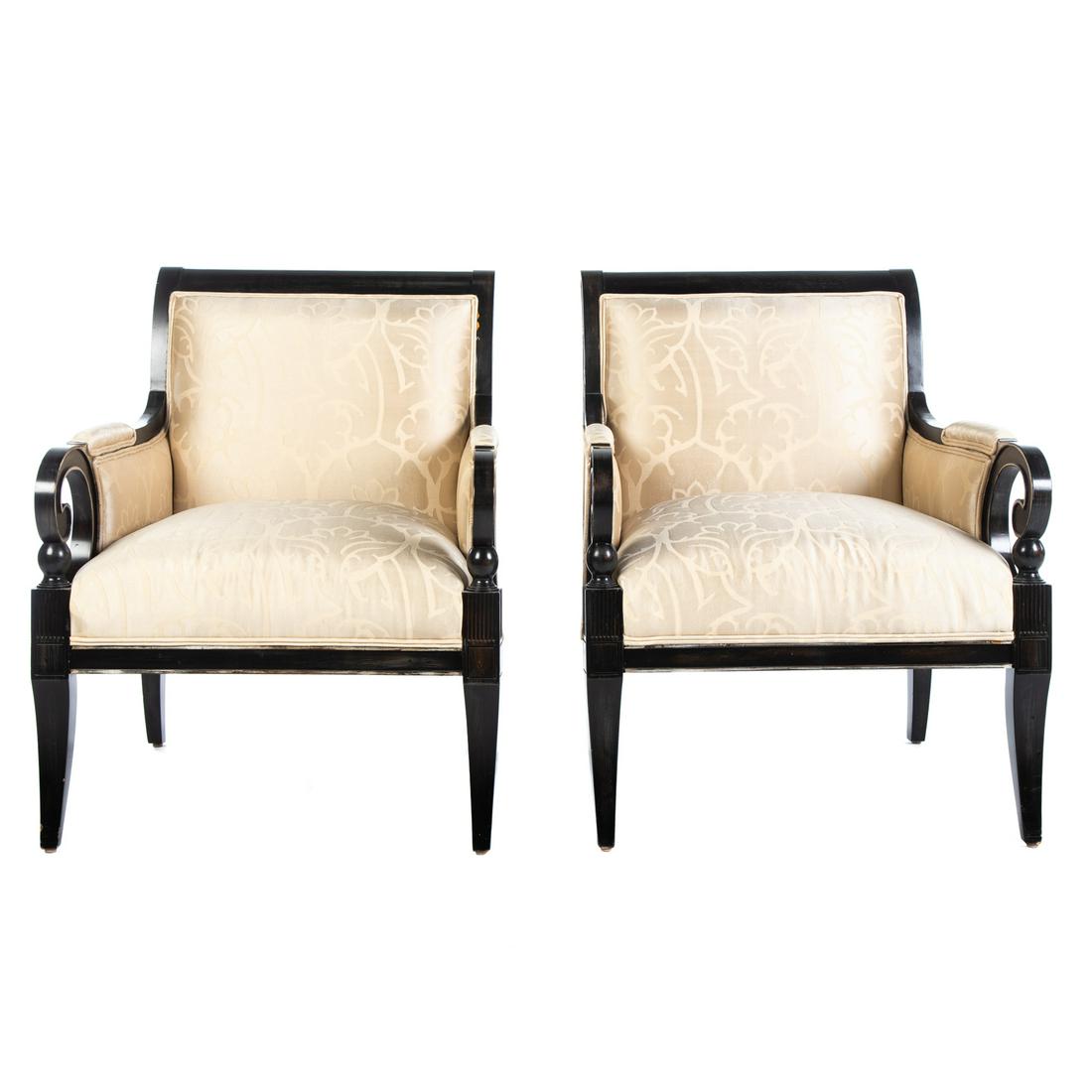 A Pair of Upholstered Arm Chairs: 20th century; with ebonized frames having rolled arms, with squared tapered legs. 35 in. H., 28 in. W., 33 in. D.