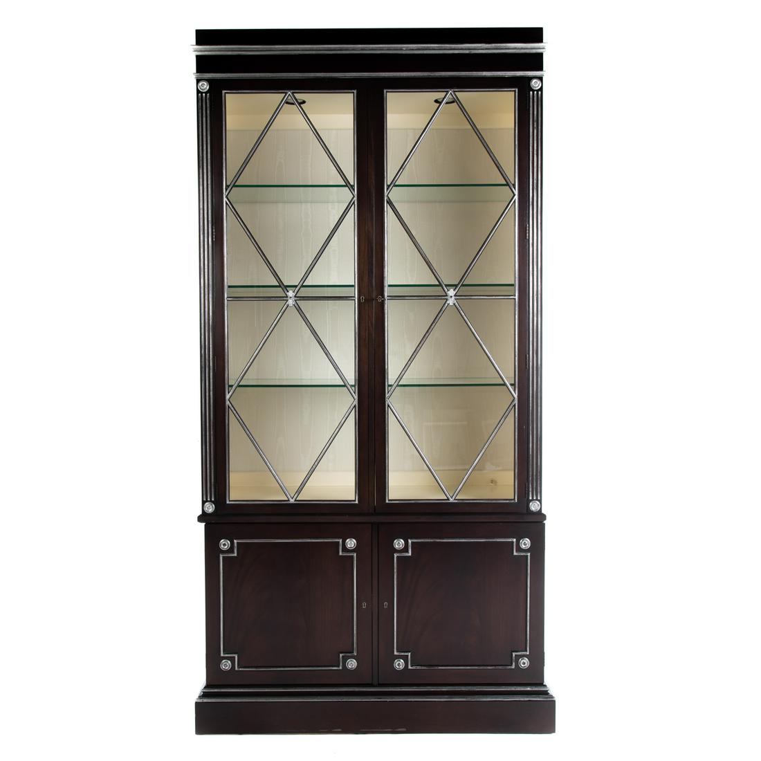 E.J. Victor Regency Style Ebonized Curio Cabinet: 20th century, two piece cabinet, with interior lights, Upper case with fabric lined back wall. Bottom case with pair of cabinet doors, silver accents throughout piece, unmarked. approx. 86 in. H., 47 