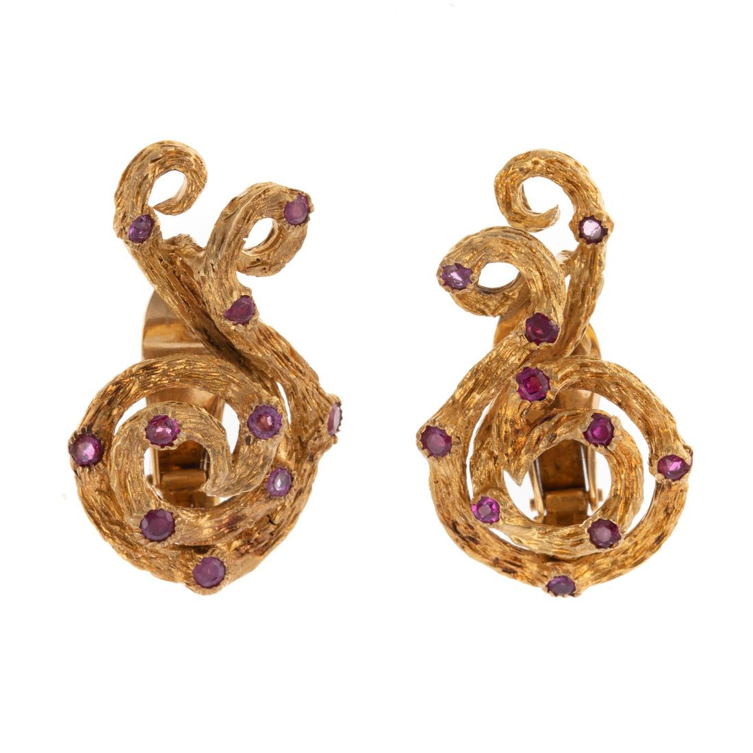 A Pair of Lalaounis Ruby Swirl Earrings in 18K: 18K yellow gold ear clips by Lalaounis featuring 20 round cut rubies set in a textured swirl design, signed "Ilias Lalaounis Greece 750," solid clip backs, 1.25 in. L, 18.6 grams The Collection of Ath