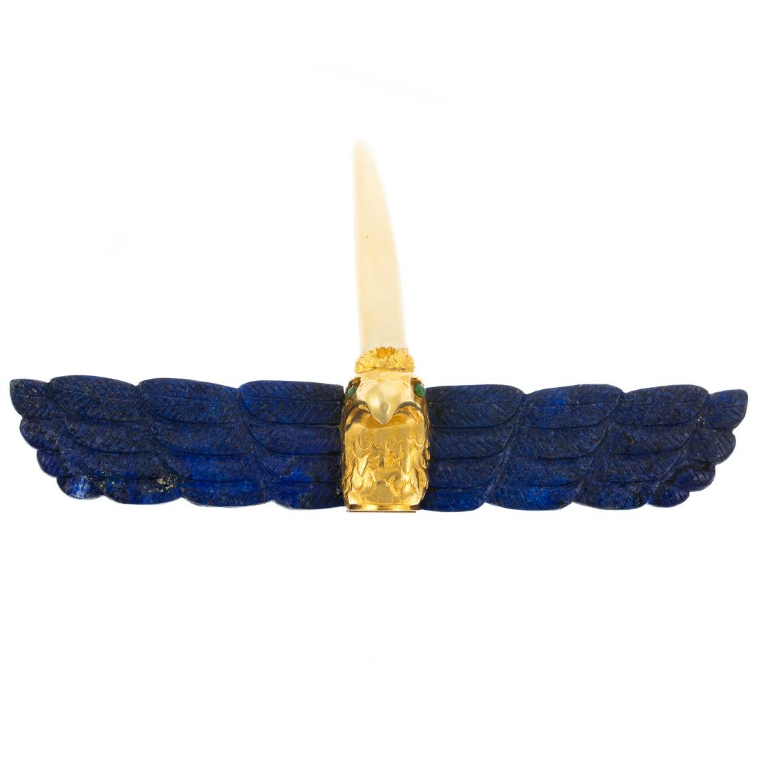 A Large 18K Yellow Gold & Lapis Horned Eagle Pin: 18K yellow gold horned eagle brooch with pendant loops on the back, hand carved lapis lazuli wings with 18K yellow gold eagle head in the center, 6.5 in. W, 136.3 grams Estate of Linda McRae Noe Laine