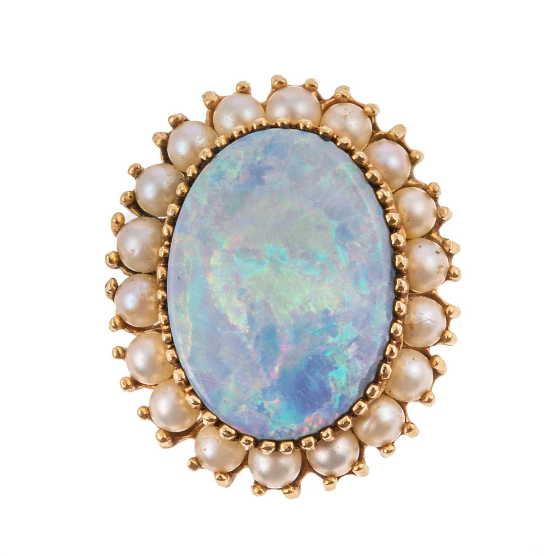 An Edwardian Opal & Seed Pearl Pin/Pendant in 14K: c. 1880, 14K yellow gold pin/pendant featuring oval opal, measuring approx. 14 x 18 mm, with strong play-of-color set in multi-prong setting in center surrounded by seed pearls, traditional pin back a