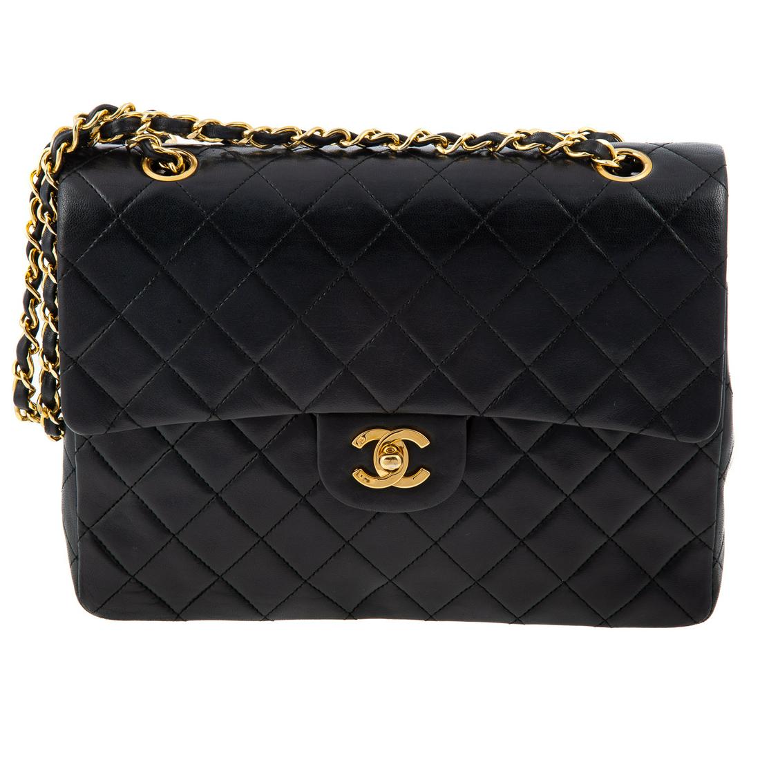 A Chanel Tall Classic Double Flap: A black lambskin leather Chanel Tall Classic Double Flap with gold tone hardware, adjustable chain-link shoulder strap and flat pocket at exterior. Burgundy leather lining with interior pockets and tu