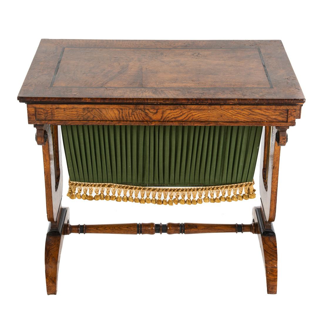 Regency Burled Elm Sewing Stand: With ebonized stringer inlay, functional drawer on each side, with cloth scrap basket, supported by a pair of lyre sides, 24 1/2 in. H., 28 in. W., 18 in. D. Purchased from Roger Winter Antiques.