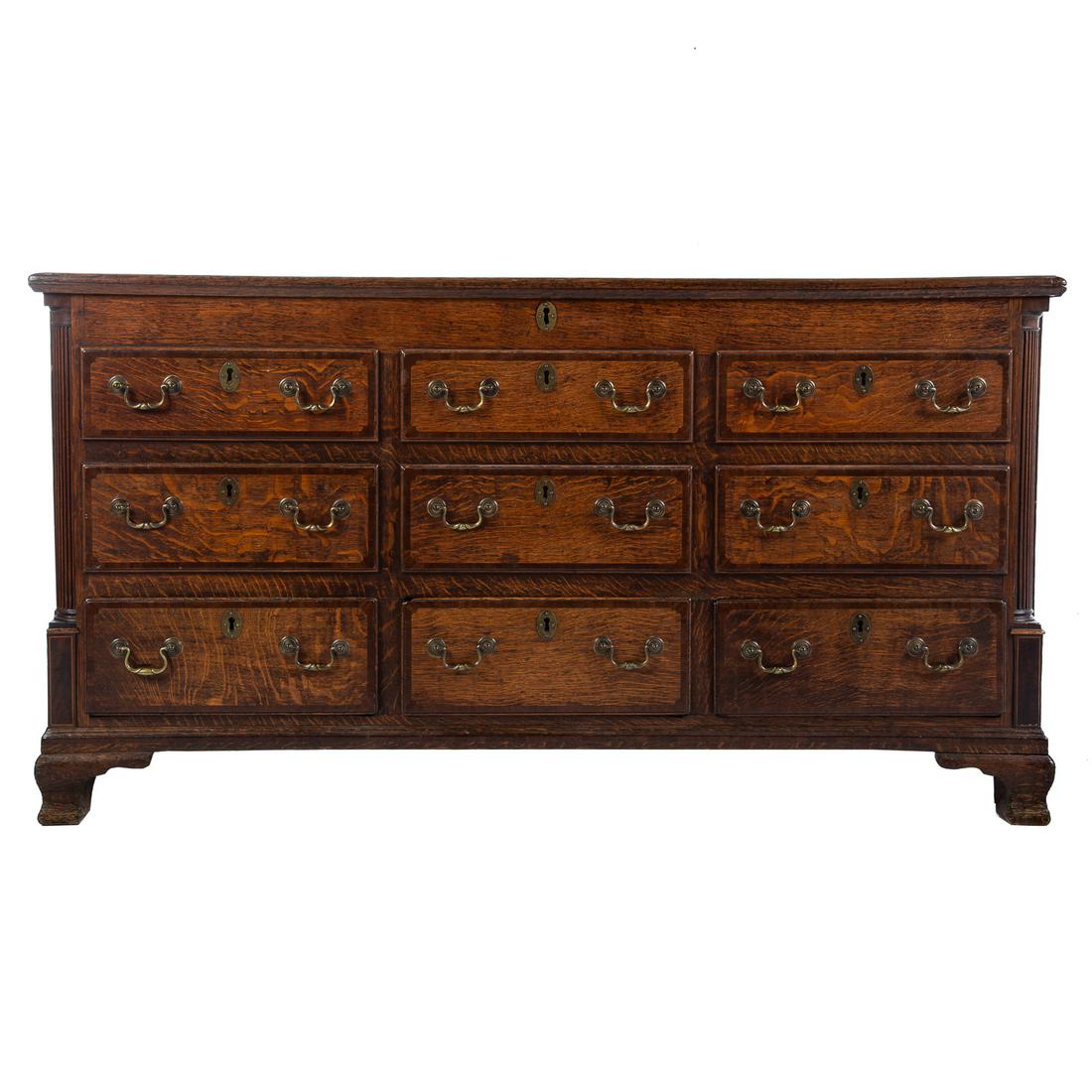 Georgian Style Oak Blanket Chest: With hinged lift lid with carved half columns, having six pseudo molded drawers and three functional molded drawers on bracket feet, 33 1/2 in. H., 63 in. W., 21 1/2 in. D.
