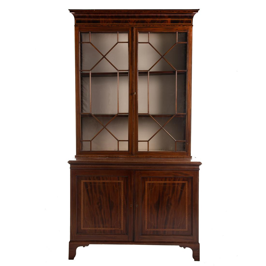 Georgian Style Inlaid Mahogany China Cupboard: Late 19th century; upper case with molded cornice, a pair of glazed panel doors with adjustable shelves; bottom case with pair of panel doors and interior with adjustable shelf, entire piece with elab