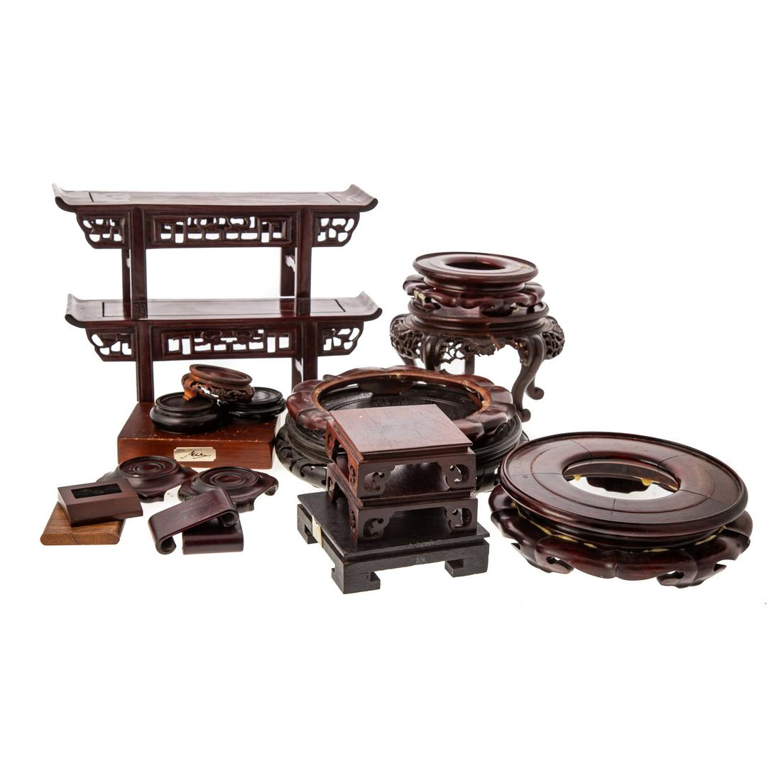 20 Assorted Asian Carved Wood Display Stands: 20th century; includes, two miniature altar table form stands, 5 in. H., 13 in. L., three square footed stands, 4 and 5 in. Sq., 5 circular stands, 2 1/2 to 9 in. Diam., 2 scroll foot stands, 3 in. L.