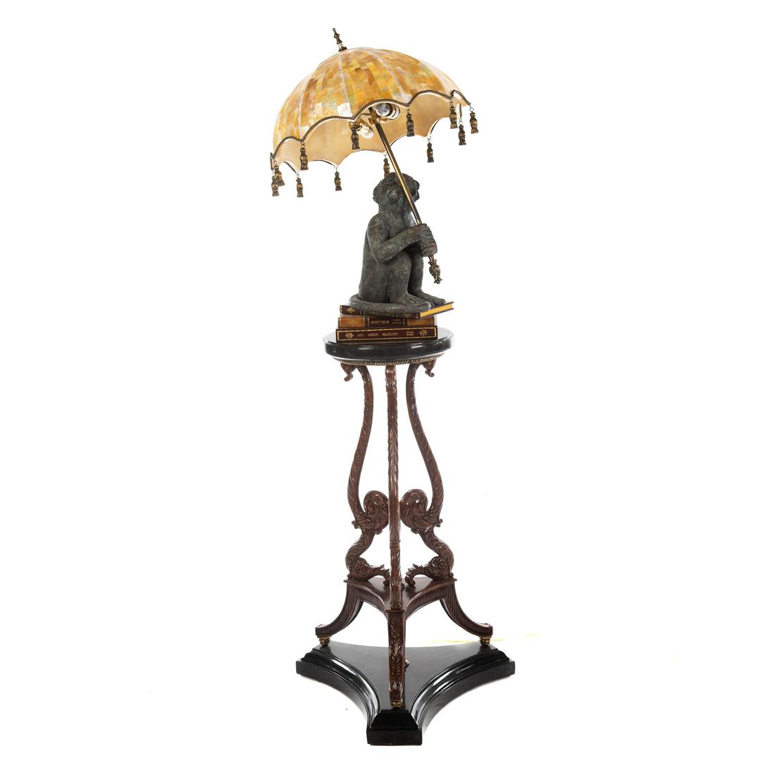Maitland Smith Monkey Parasol Floor Lamp: Whimsical lamp, featuring verdigris metal monkey seated on book stack holding penshell parasol shade, on circular marble veneer base, supported by three carved wood scroll supports, on marble tri form