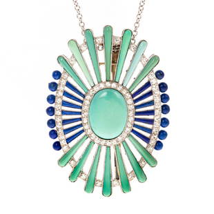 An Art Deco Turquoise, Lapis & Diamond Pin/Pendant: c. 1920, 18K white gold pin/pendant featuring oval turquoise in center with starburst design comprising carved turquoise and lapis lazuli with diamond halos, approx. diamond weight 1.70 ctw, 1.5 in.