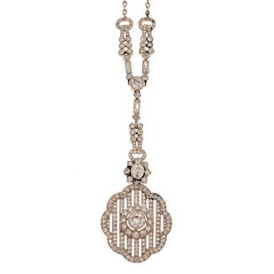 An Impressive Platinum Art Deco Necklace: c. 1920, platinum Art Deco necklace featuring a geometric drop pendant featuring three old European cut diamonds bezel set with a milgrain edge, bottom diamond weighing approx. 0.90 ct, center