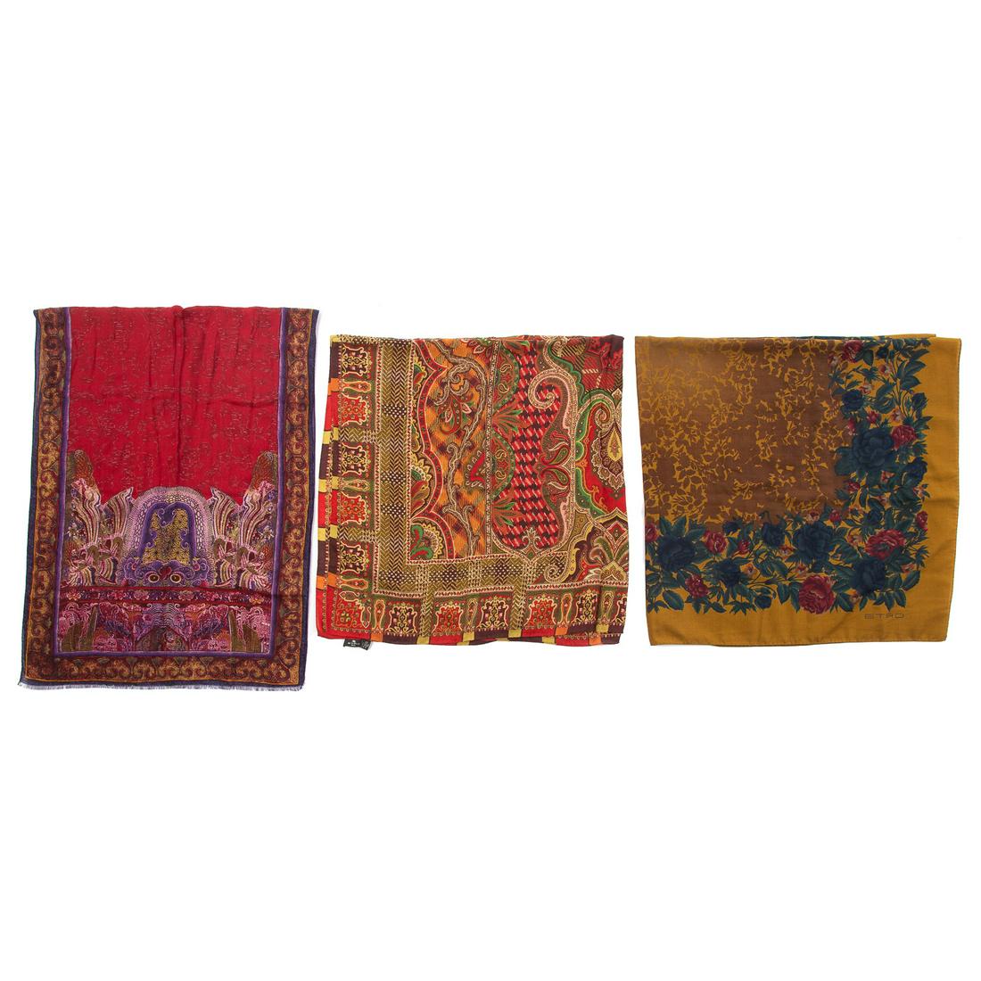 Three Etro Silk and Wool Mufflers: 1) A red and multicolor Etro silk and wool scarf with paisley motif and hand rolled edges. Measuring: 52 in. L, 52 in. D 2) a purple and multicolor Etro silk and wool scarf with paisley motif, fringe