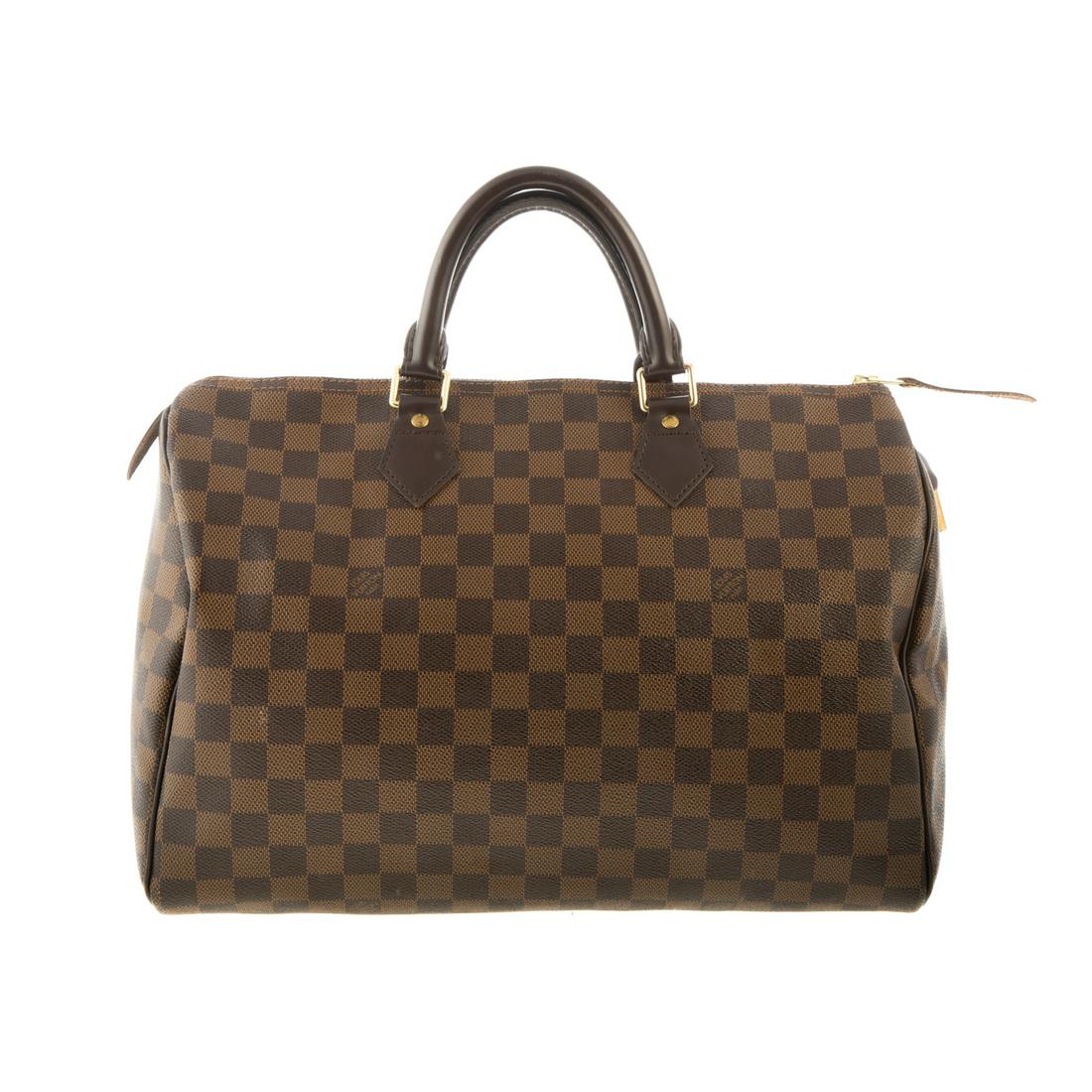 A Louis Vuitton Damier Ebene Speedy 35: A brown and tan coated canvas Louis Vuitton Damier Ebene Speedy 35 with brass hardware, dual rolled top handles and Vachetta leather trim. Canvas lining with flat pocket at interior and zipper closure