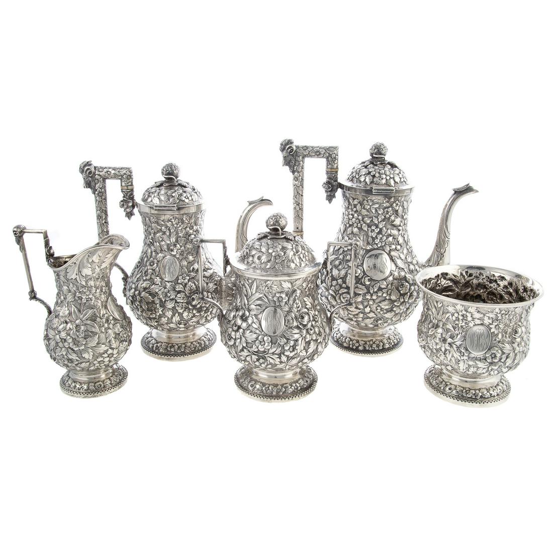 A.E. Warner Sterling Repousse Tea & Coffee Service: Baltimore, 19th century, A.E. Warner and 11.2 silver standard stamped on the underside. Five pieces comprising a coffee pot, teapot, creamer, sugar and waste bowl. Baluster-form, with a variety of det
