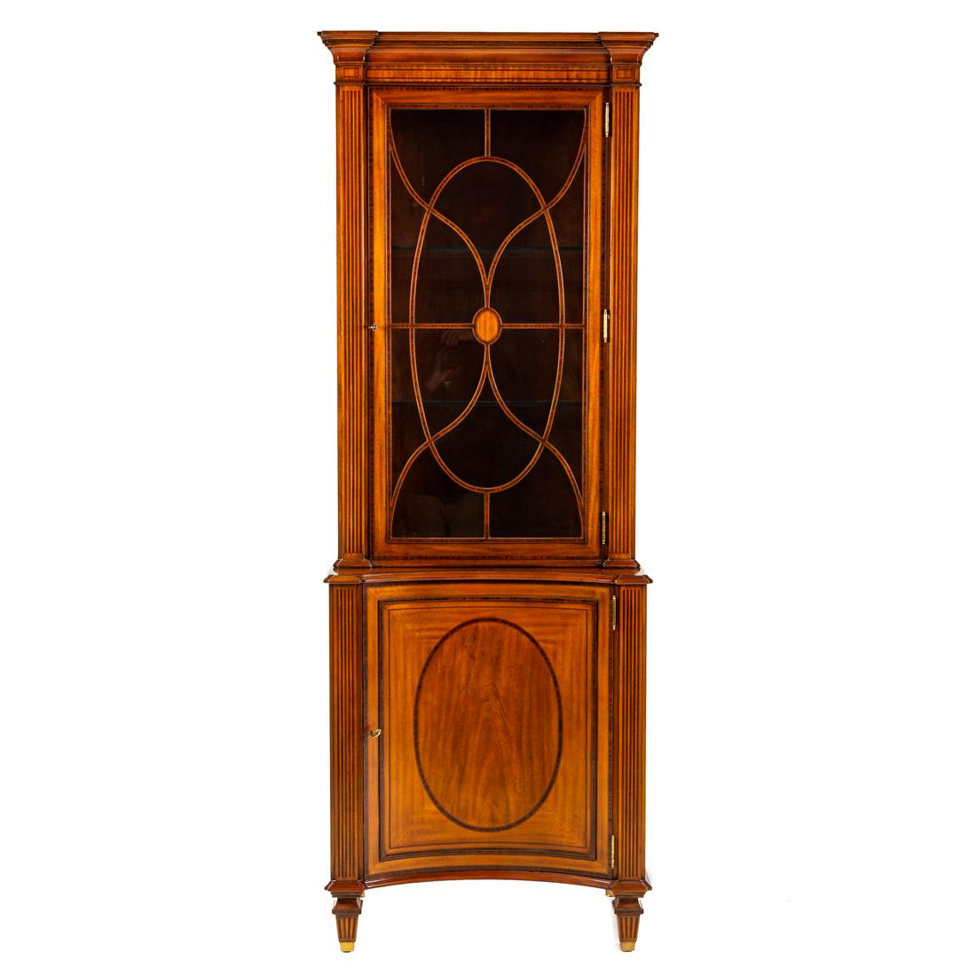 Maitland Smith Inlaid Curio Cabinet: 20th century; with molded cornice, with elaborate string and reeded inlays, single glass panel door, with adjustable glass shelves, illuminated top over similar inlayed bottom case with curved panel d