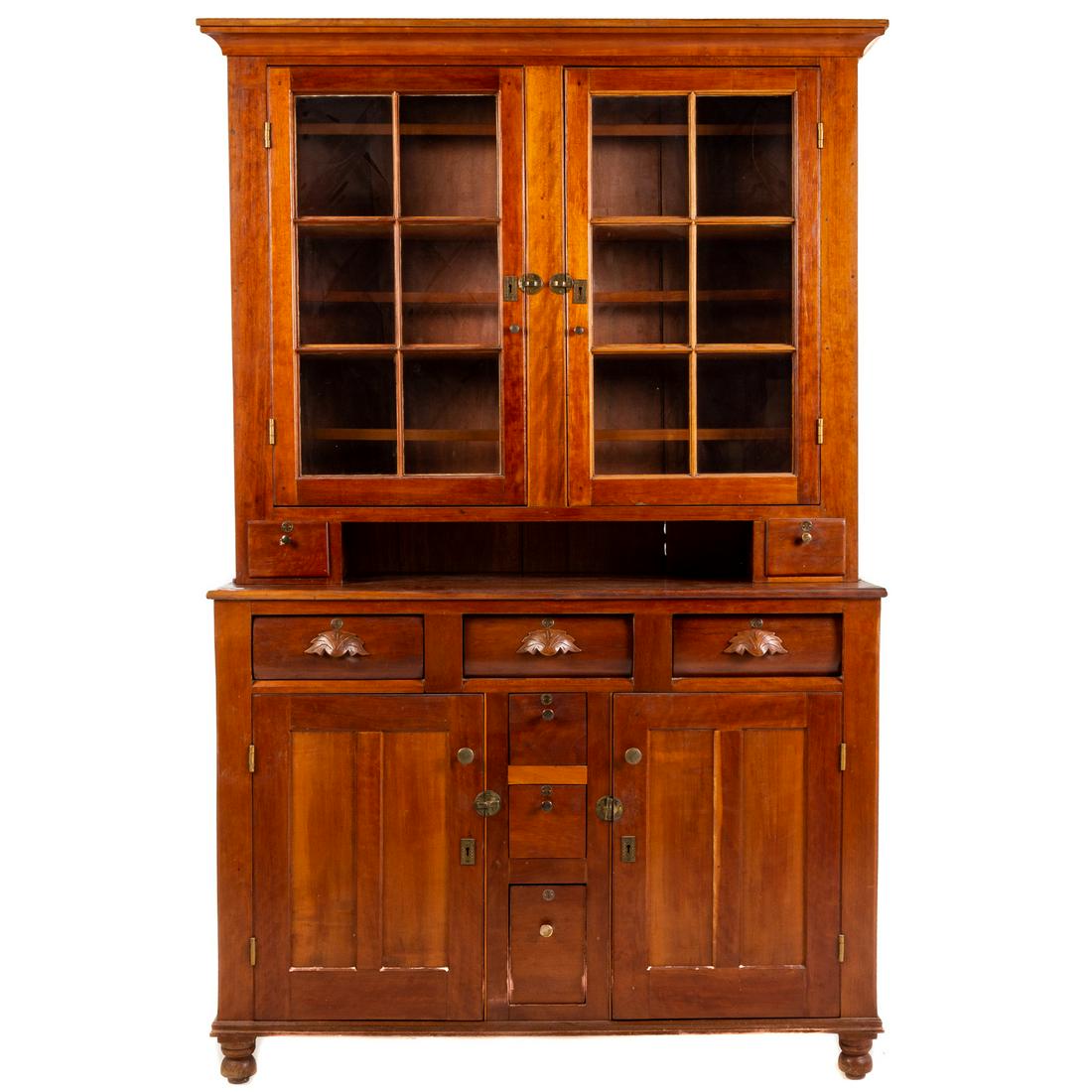 American Cherry Wood Stepback Cupboard: Uppercase with molded cornice, with a pair of glass panel doors, with interior fixed shelves and a pair of candle drawers; bottom case with three short drawers, center with three candle drawers, and t