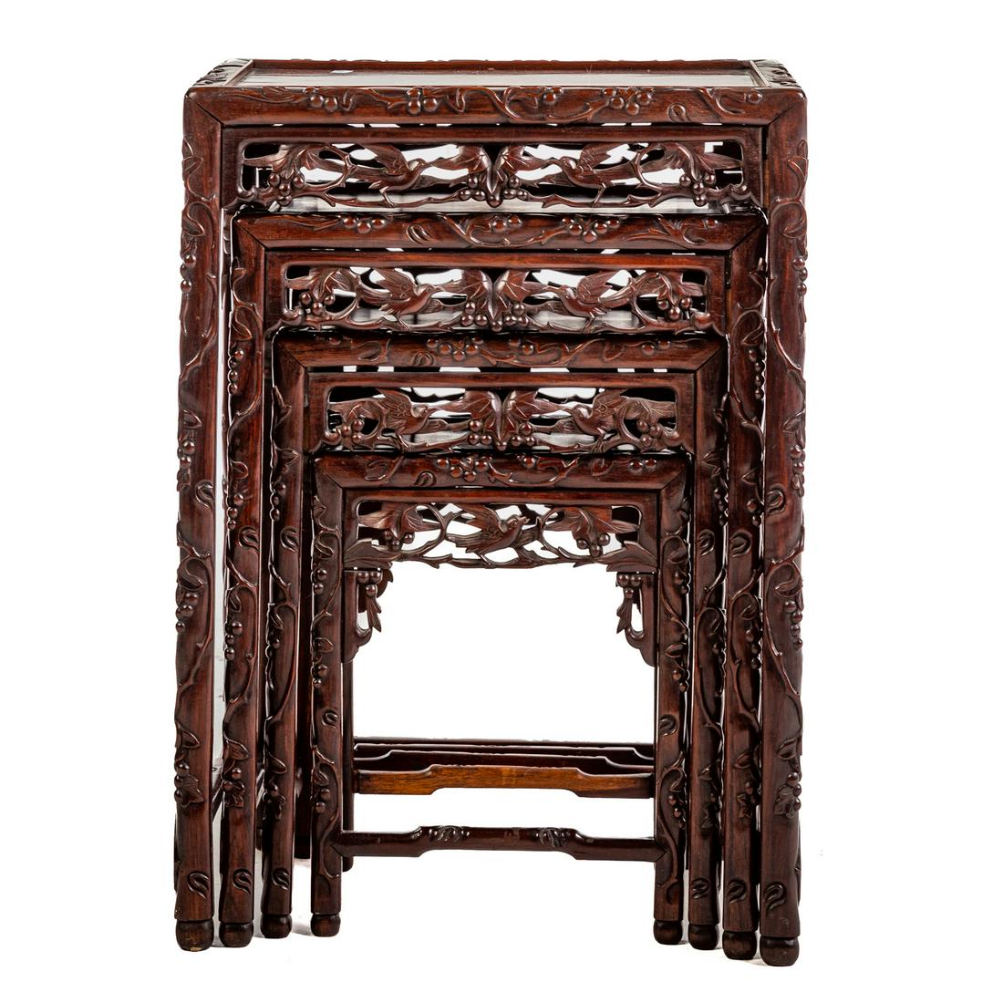 Set of Four Chinese Rosewood Nesting Tables: Graduated set of four tables, with elaborately carved skirts and vine relief on legs, largest, 28 in. H., 19 in. W., 14 in. D.