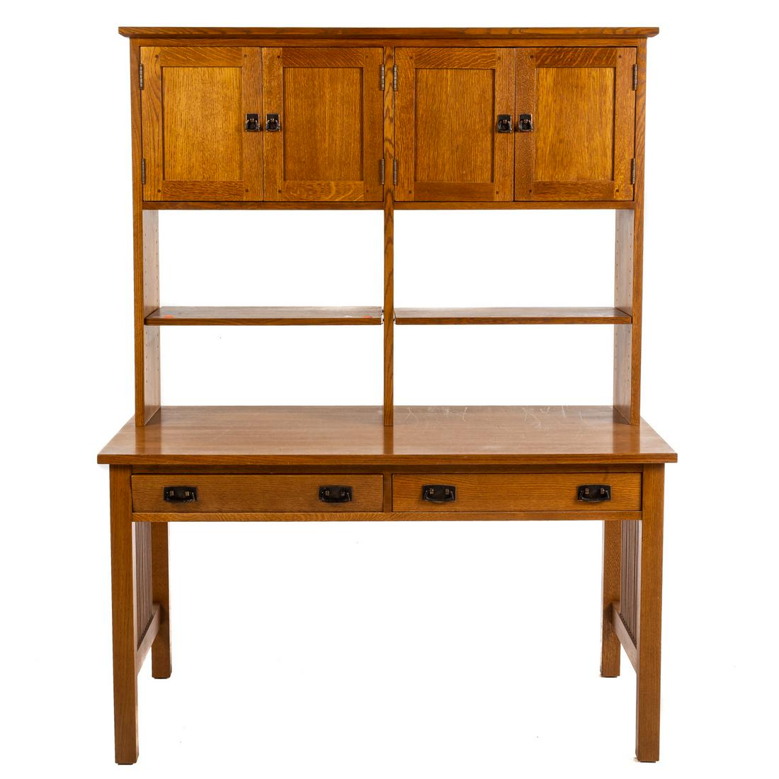 Stickley Mission Style Oak Desk with Hutch: Third quarter, 20th century; hutch section with a pair of cabinet sections having paneled doors with hammered copper hardware, writing table with a pair of short drawers, 70 in. H., 53.5 in. W., 30 in