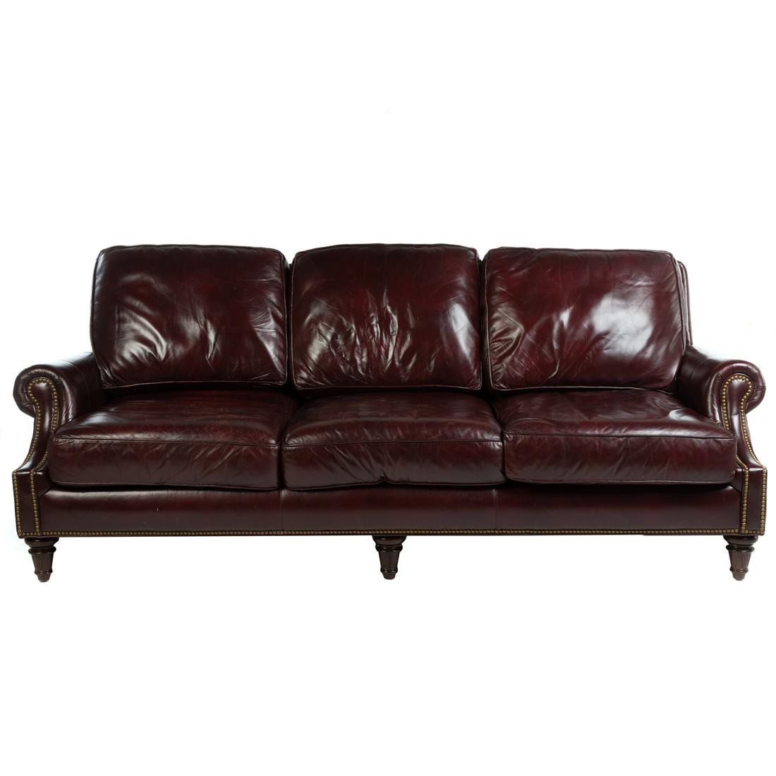 Hancock & Moore Leather Three-Cushion Sofa: 20th century; burgundy leather, with brass nail heads, on turned legs having removable cushions, 34.5 in. H., 91 in. W., 26 in. D.