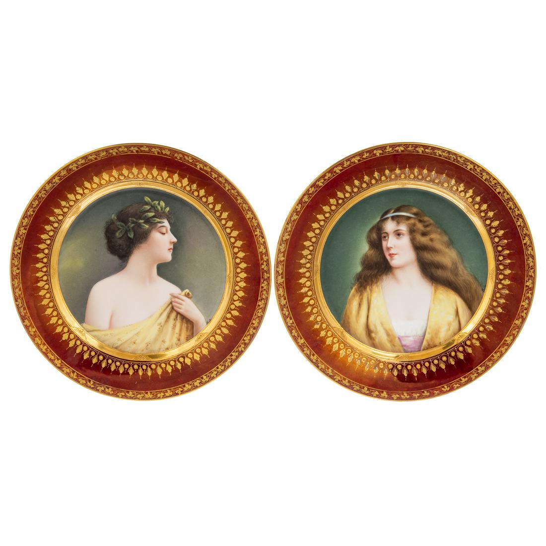 A Pair of Vienna Porcelain Classical Portrait Plates: Early 20th century; each with burgundy and gilt border borders and central portrait of classical beauty, with Vienna mark on verso, 9 1/2 in. Diam.