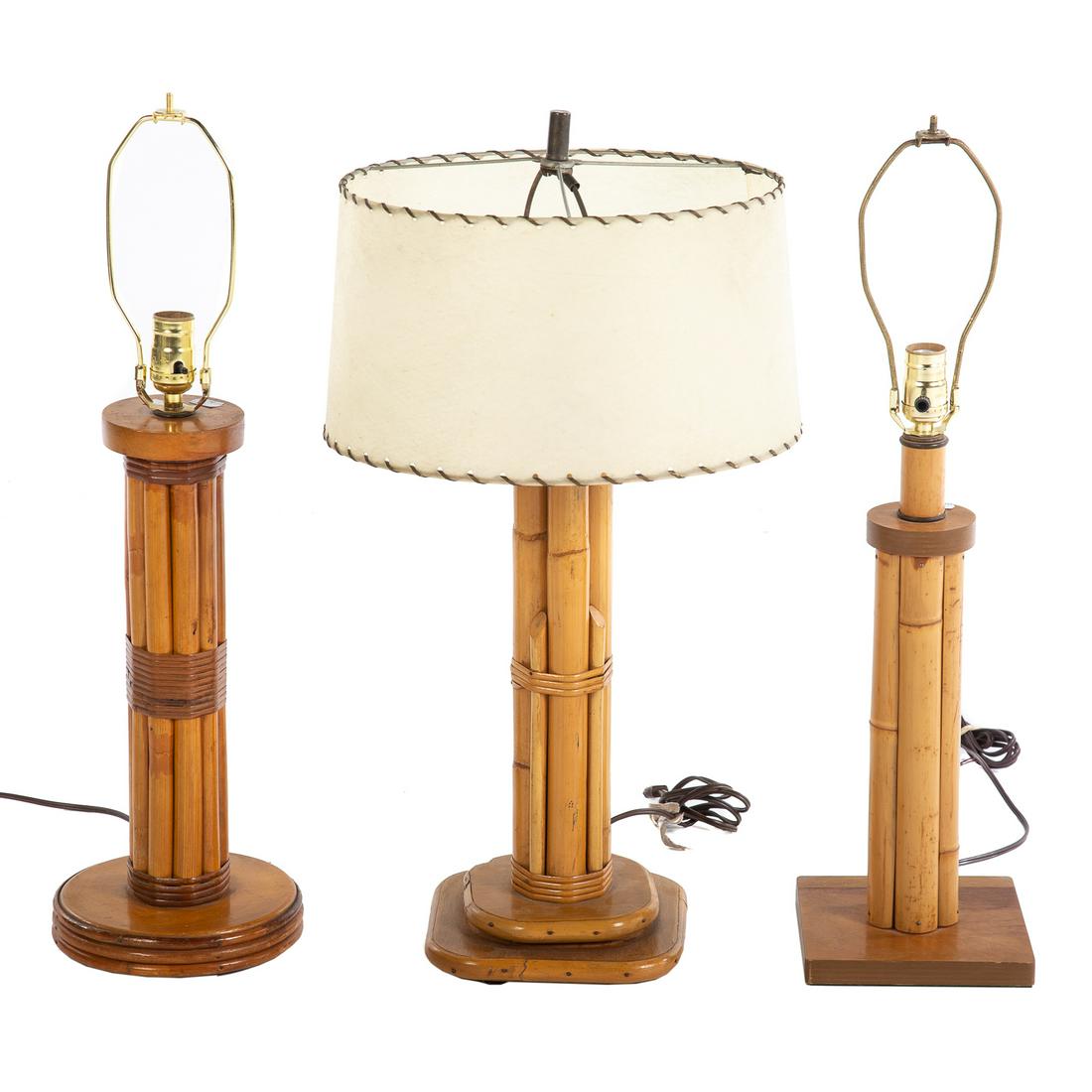 Three Paul Frankl Style Rattan Table Lamps: Mid-century; with circular and square shaped bases, and one with velum shade, all approx. 20 in. tall