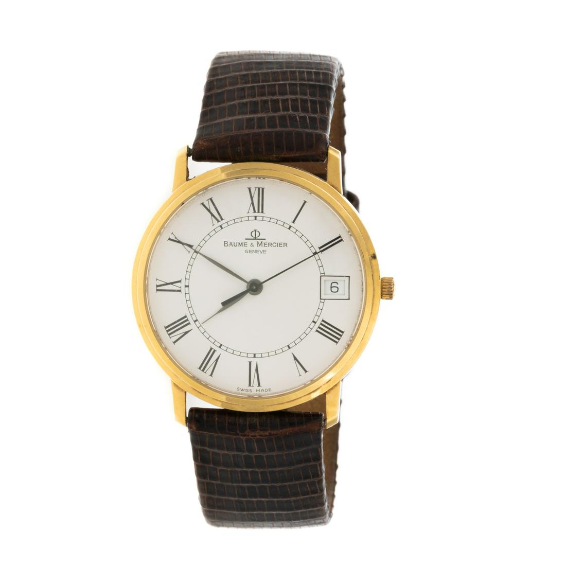 A Baume & Mercier Classic Wrist Watch in 14K: 14K yellow gold Baume & Mercier wrist watch, round dial with Roma numerals and date window, back stamped with #4055781, MV045093, brown lizard strap, quartz movement, 24.2 grams From the Estate of L. 