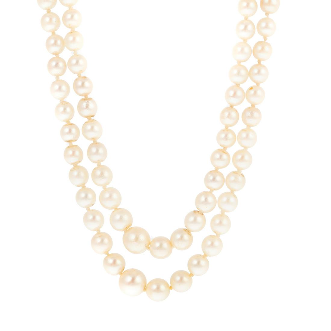 A Double-Strand Pearl Necklace with Amethyst Clasp: Nesting double strand of graduated pearls, measuring 4.5 mm in the back to 8.5 mm in the front with 9K yellow gold pearl and amethyst clasp, 17 in. L, 44.6 grams