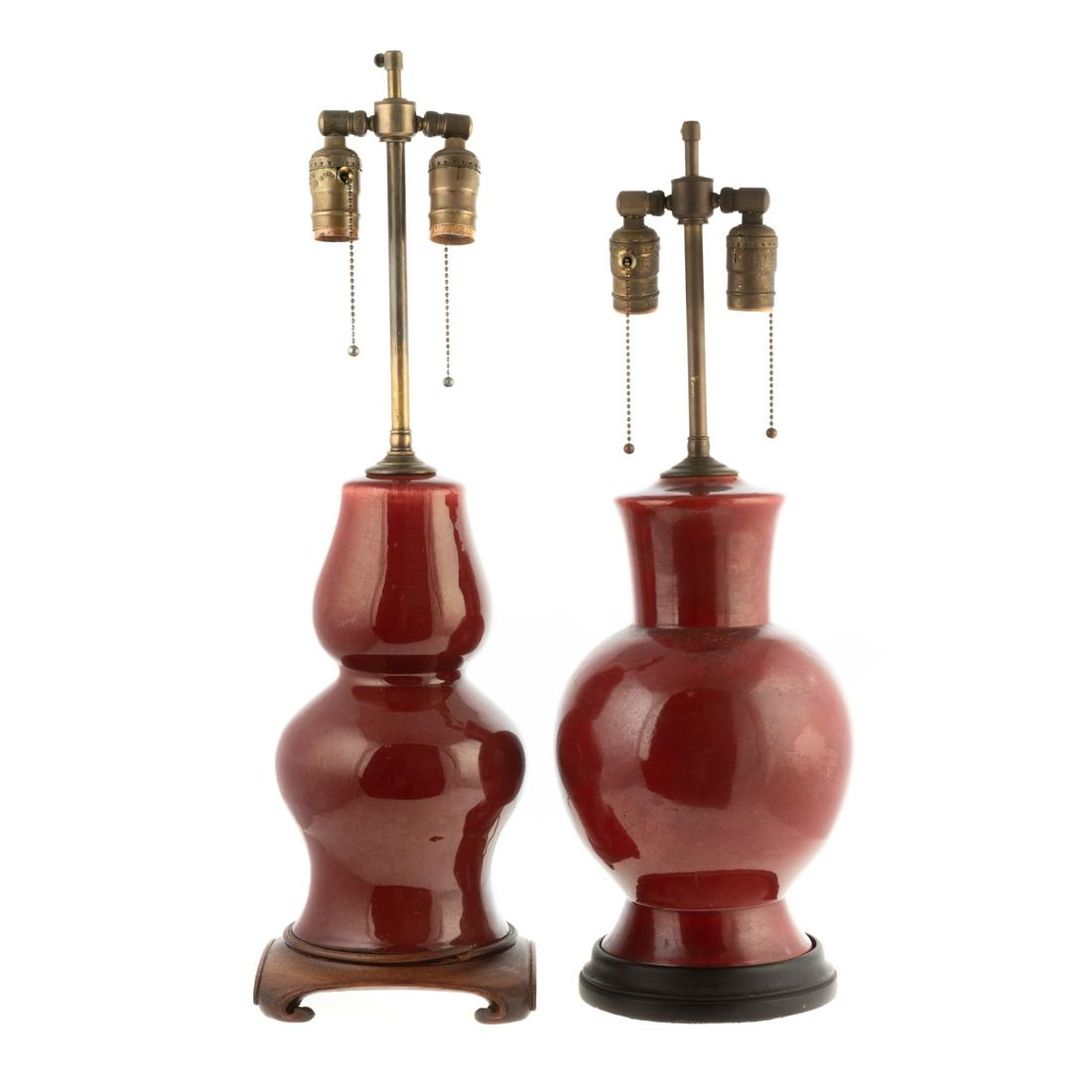 Two Chinese Export Sang de Boeuf Lamps: 20th century; double gourd and Ku form lamp bases, mounted on Asian style wood bases, 23 and 25 in. H. Estate of Valerie Sabet, socialite, antique dealer and collector, New York, NY.