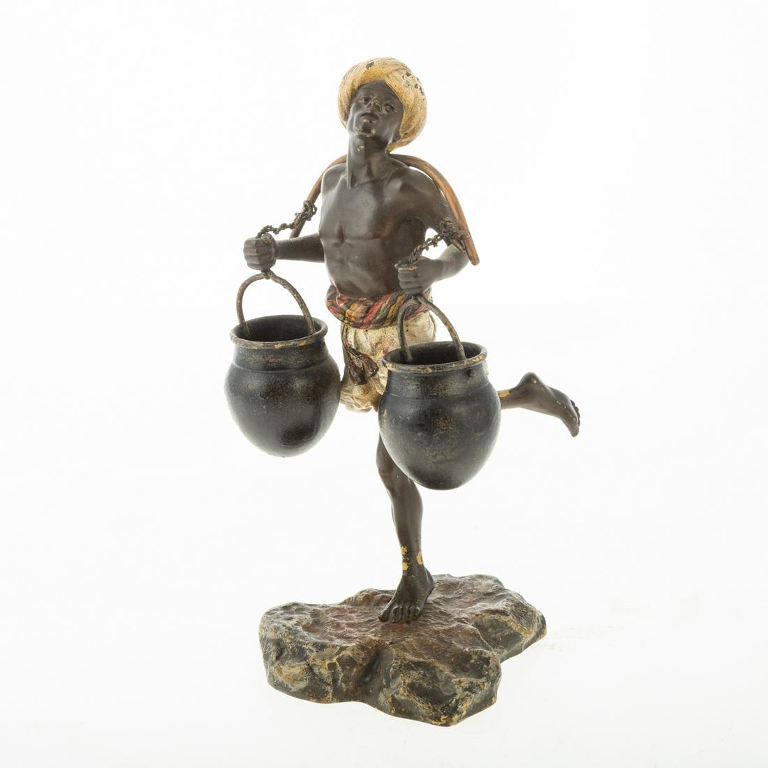 Franz Xavier Bergman Cold Painted Bronze Figure: Austrian, 1861-1936; marked twice with foundry mark and ''3412'', further marked ''Geschutzt''. Modeled as a water carrier, balancing two buckets, upon a naturalistic base, 6 3/4 in. H. Estate of Vale