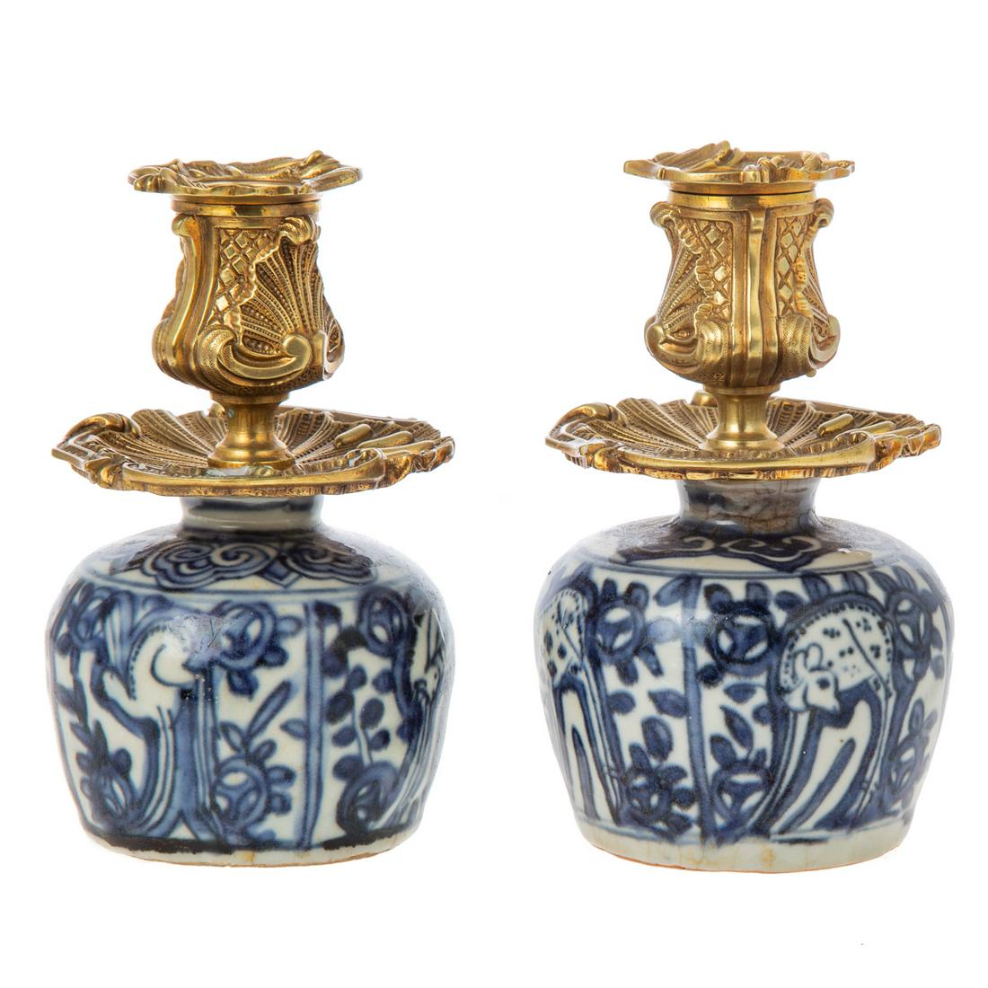 A Pair of Chinese Export Blue/White Vase Candle Holders: Ming Period, Chongzhen Era, circa 1640 blue/white floral and sacred deer decorated jars, with later gilt metal candle socket and drip pan. 6 in. H.