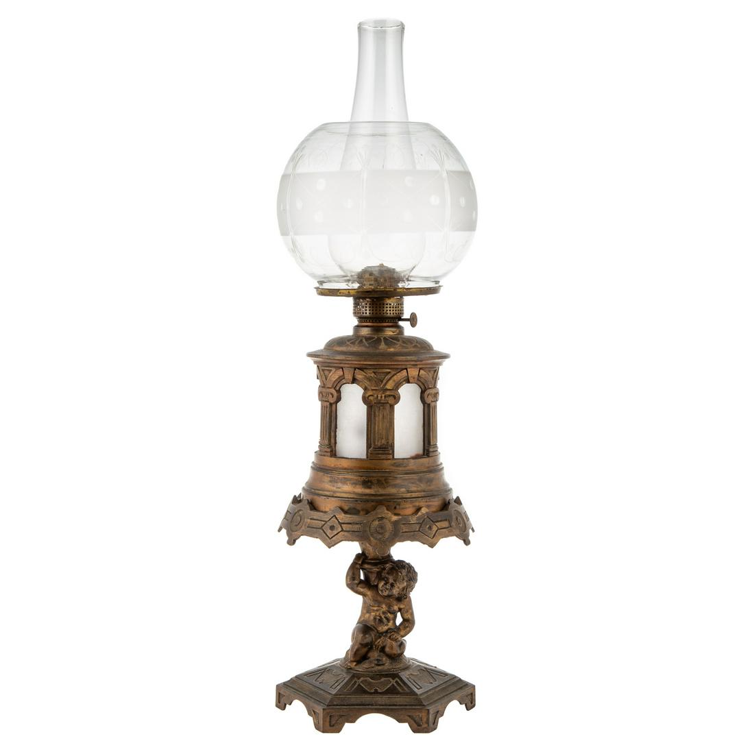 Victorian Cast Iron Oil Lamp: Second half, 19th century; two part lamp with hexagonal base with putto supporting stand that has classically influenced, lamp with frosted glass well with acid etched glass globe, 24 in. H.