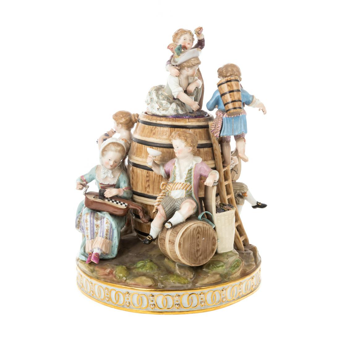 Meissen Porcelain Figural Tobacco Jar: 20th century; figural group of seven children making wine in large barrel, some playing musical instruments, the others making wine, lid interior has depression for sponge, gilt accented raised scroll