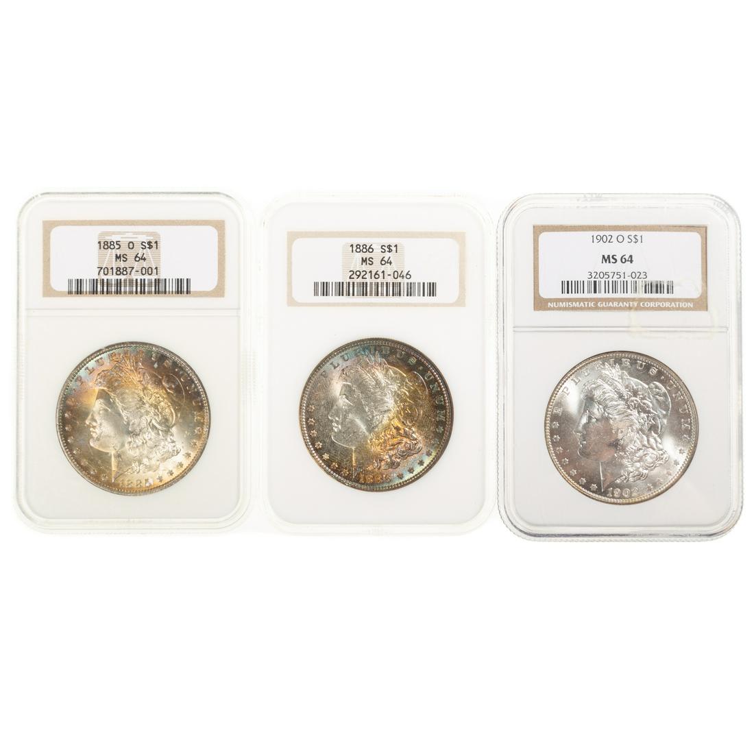 Three Toned NGC 64 Silver Dollars: 1885-O NGC 64 Both sides with eye appealing rainbow colors with full luster; 1886 NGC MS64 with beautiful rainbow toning on obverse with reverse just as nice - just a few marks away from either 65 or