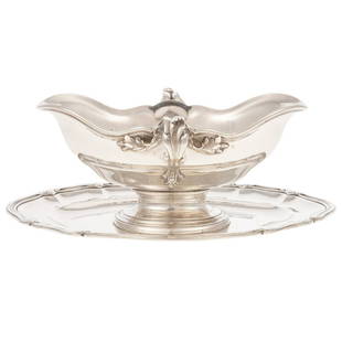 French Sterling Sauceboat Retailed by Tiffany: Robert Linzeler & Cie, 1897-1926, 950 silver standard, retailed by Tiffany & Co., Paris. Shaped oval, with flaring serpentine rim, foliate capped handles, attached conforming undertray, applied monogr