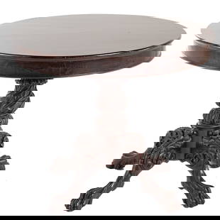 American Classical Carved Mahogany Center Table: Circa 1830; molded edge with elaborate foliate carved pedestal, legs, and paw feet, 29 in. H., 36 in. Diam.