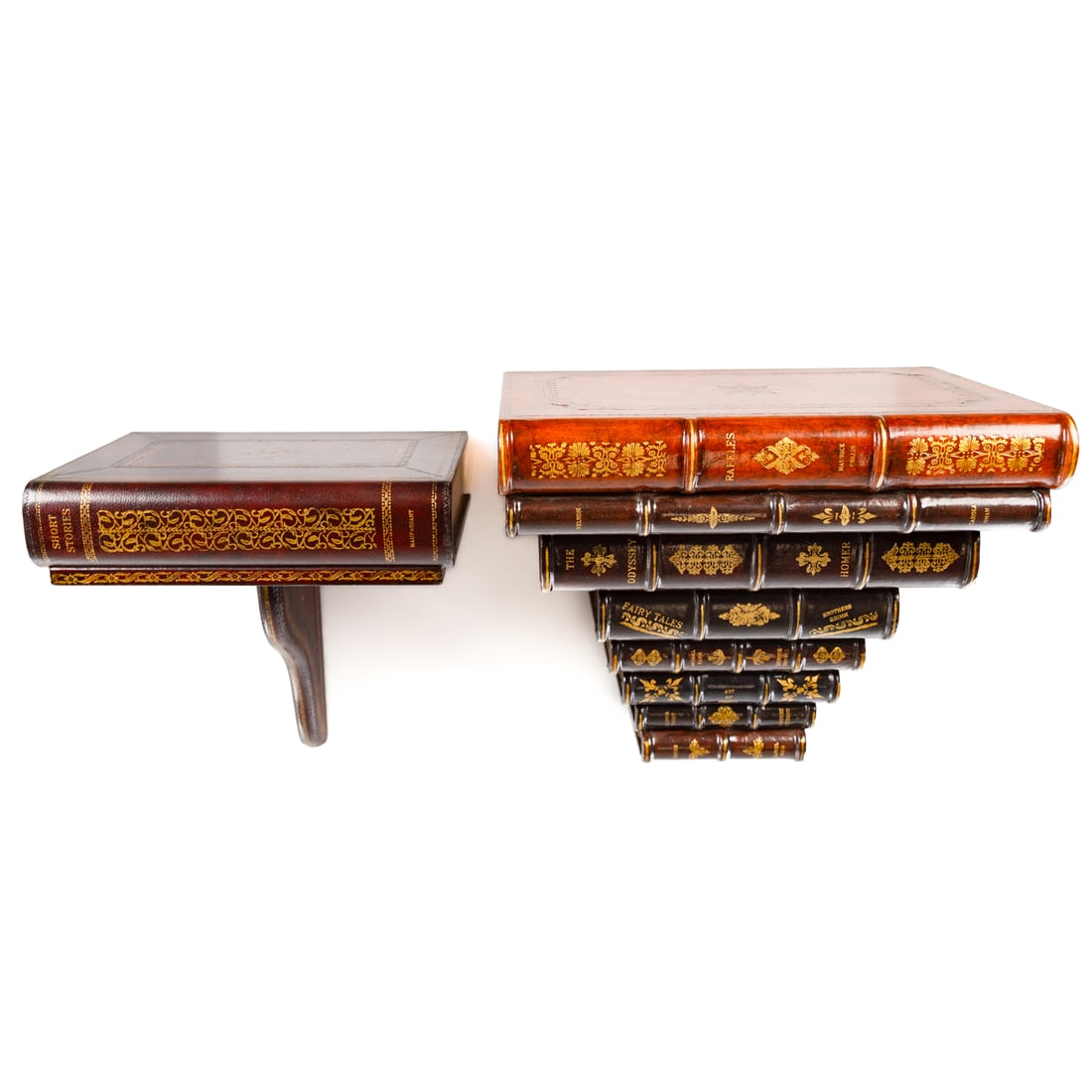 Two Maitland Smith Book Wall Brackets: 20th century; larger modeled as graduated wood and tooled leather stack of books, 13 in. H., 15 in. W., 10 in. D., and smaller similar bracket with one large volume and support bracket, 12 in. H., 12