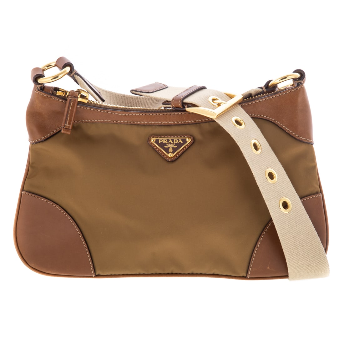 A Prada Small Crossbody Zip: A beige and brown nylon canvas Prada Small Crossbody Zip with gold tone hardware and a flat beige canvas adjustable crossbody strap. One interior zipper wall pocket with zipper closure at top. Measuri