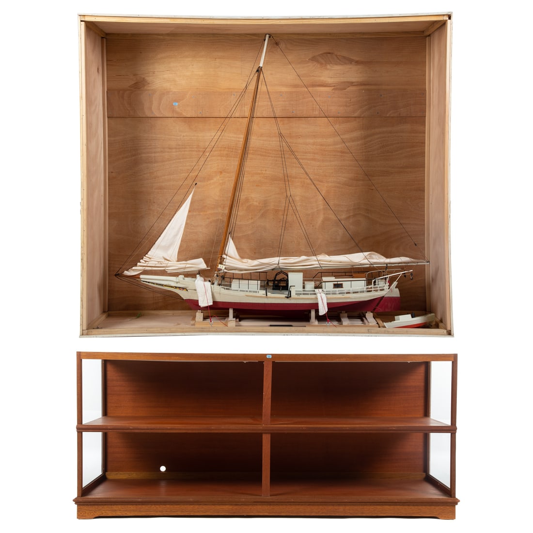 Large Chesapeake Skipjack Model with Stand: 20th century; large scratch built skipjack model with cloth sails and rigging and dingy, 63 in. H., 64 in. L., with shipping crate, with shelf display, 34 in. H., 78 in. W., 21 in. D.