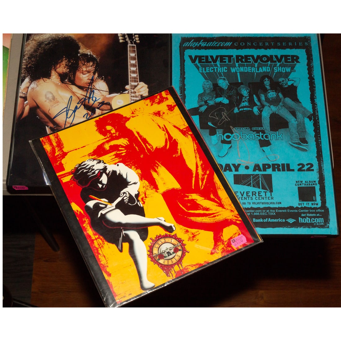 Guns N' Roses & Slash: Memorabilia: Comprising a signed photograph of Slash and Axl; a Velvet Revolver concert poster; and a Guns n' Roses, "Use Your Illusion I & II" concert program Provenance: From a lifelong collection of a Baltimore