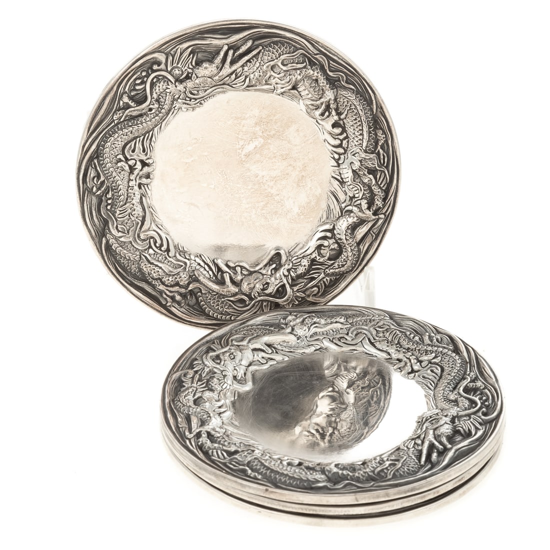 Four Japanese Sanju Saku Sterling Saucers: Meiji period, 1868-1912, Yokohama, with turtle and Jungin sterling standard mark. Circular, repousse dragon border, 3 7/8 in. Diam., 13.35 ozt.