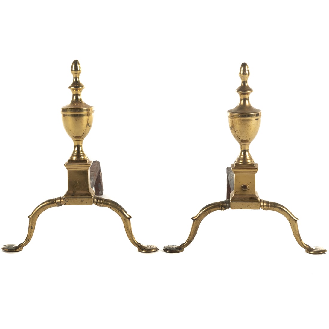 A Pair of Federal Brass Penny Foot Andirons: Circa 1790-1810, probably Philadelphia, urn tops with large "penny foot" disc foot, with cast iron firedogs, 18 in. H, 20 in. L