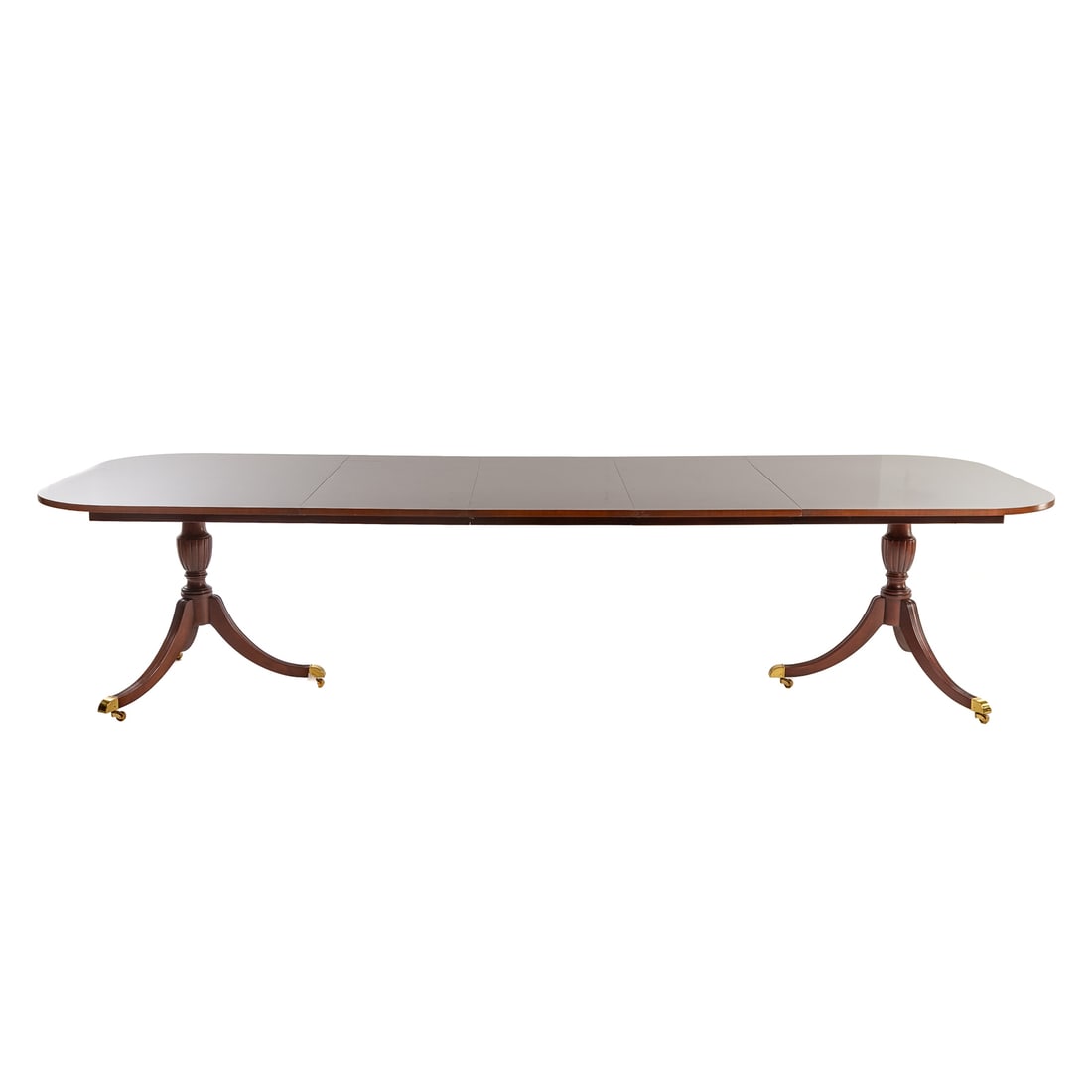Federal Style Double Pedestal Dining Table: 20th century, in the Duncan Phyfe manner. Banded and string inlaid top over two pedestals with carved urn and reeded sabre legs, with three extension leaves, 30 in. H, 68 in. W, 45 in. D